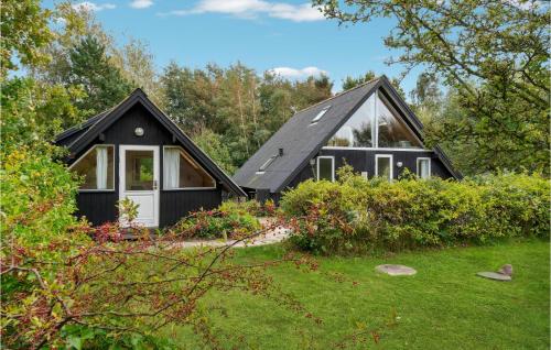a black house with a pitched roof at Lovely Home In Samsø With Wifi in Tanderup