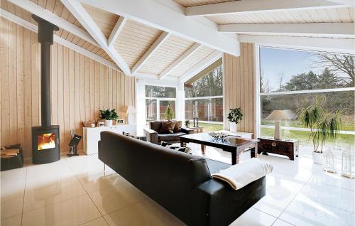 a living room with a couch and a fireplace at Three-Bedroom Holiday Home In Sjallands Odde in Tjørneholm