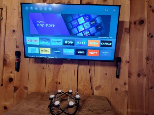 a flat screen tv on top of a wooden wall at Le Saloon in Aire-sur-lʼAdour