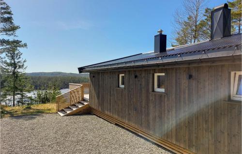 a wooden building with a deck and a house at 3 Bedroom Lovely Home In Vatnestrøm in Birkeland