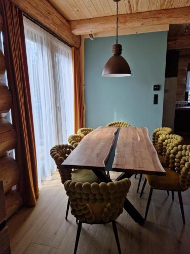 a wooden table and chairs in a room at Chata Braci Warchały in Warchały