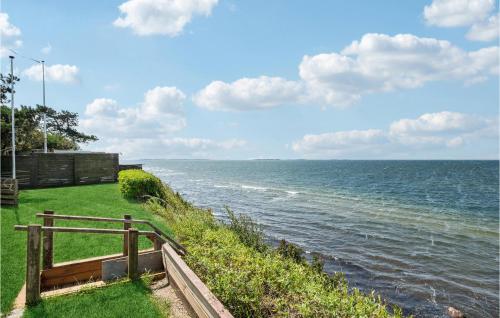a view of the ocean with a wooden fence at Cozy Home In Lundby With Kitchen in Lundby