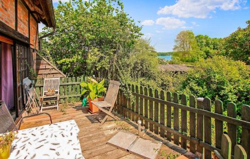 a wooden deck with two chairs and a fence at Ferienhaus Jabel in Jabel