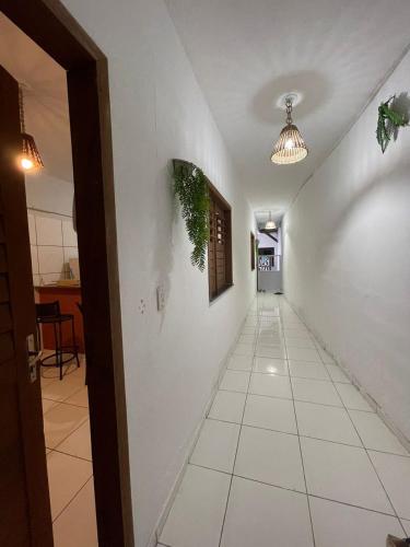 a hallway with a white wall and a ceiling at Flat Doce Jeri in Jericoacoara