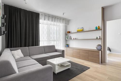 a living room with a couch and a table at Poznań Apartments Towarowa in Poznań
