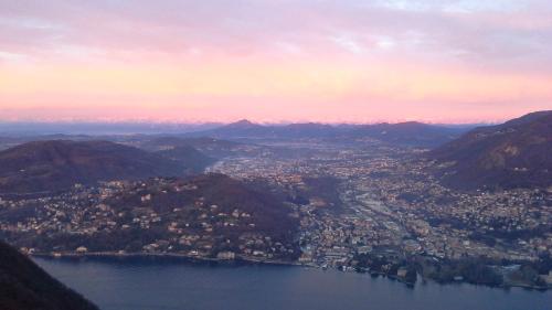 an aerial view of a city on the water with mountains at B&B Il Balcone sul Lago in Brunate