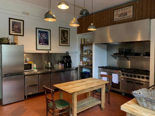a kitchen with a wooden table and a kitchen with a stove at Preston House in Abbeyleix