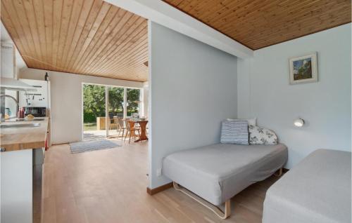 a bedroom with a bed in a room with a kitchen at Nice Apartment In Aakirkeby With Wifi in Åkirkeby
