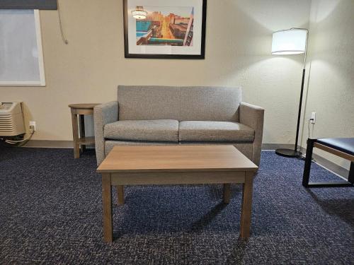 a living room with a couch and a coffee table at Baymont by Wyndham Davenport in Davenport