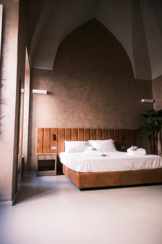 a bedroom with a large bed in a room at Relais Ena in Gallipoli