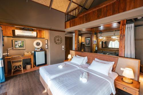 a bedroom with a large white bed in a room at Yatika Boutique Chiang Dao in Chiang Dao
