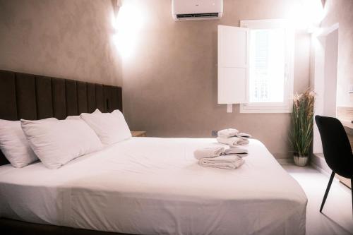 a bedroom with a bed with towels on it at Relais Ena in Gallipoli