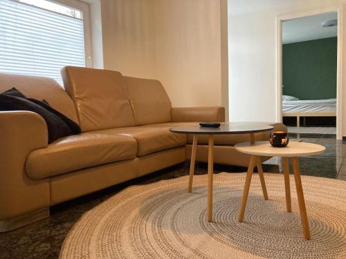 a living room with a couch and two tables at Ferienwohnung Abraham in Schellhorn