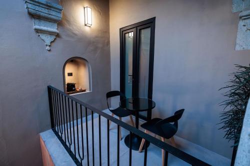 a staircase with black chairs and a table on it at Casa 1800 Oaxaca Boutique Hotel City Center based in Oaxaca City