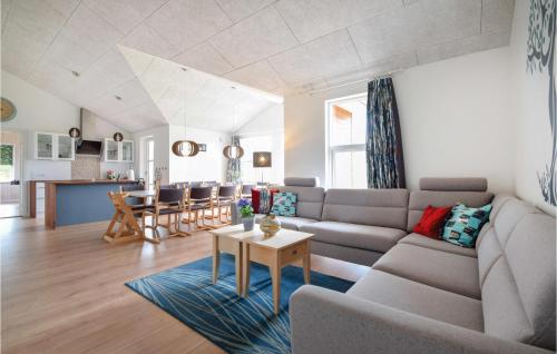 a living room with a couch and a table at Four-Bedroom Holiday Home In Ejstrupholm in Ejstrup