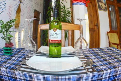 a bottle of wine sitting on top of a table at Sanctuary Cove Guest House in Polonnaruwa