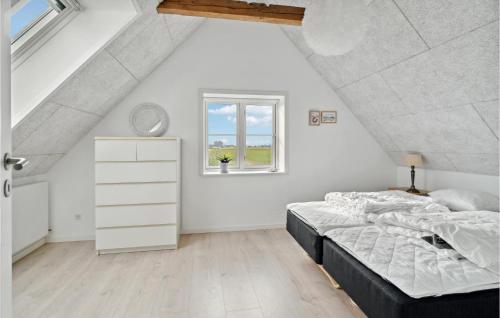 a white bedroom with a bed and a window at 3 Bedroom Stunning Home In Samsø in Ballen