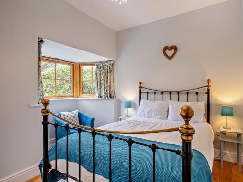 a bedroom with a bed and a window at 1 bed property in Shaftesbury 46774 in Bourton