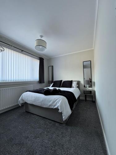 a bedroom with a large bed and a mirror at Donvale Road, Washington in Washington