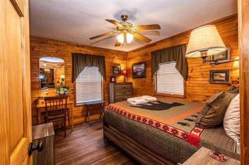 a bedroom with a bed and a ceiling fan at Blue Mist Mountain Retreat in Whittier