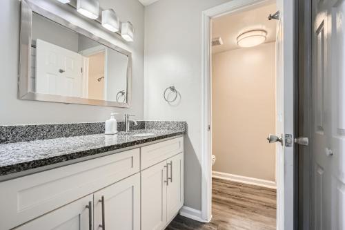 a bathroom with a sink and a mirror at Crest At East Cobb1820e Comfort, Spacious 2bd 2bt in Marietta