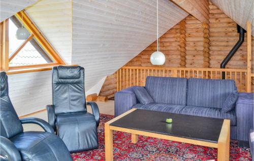 a living room with a couch and two chairs at Holiday Home Brombærvej Xi in Lem