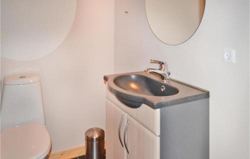 a bathroom with a sink and a toilet at Holiday Home Brombærvej Xi in Lem