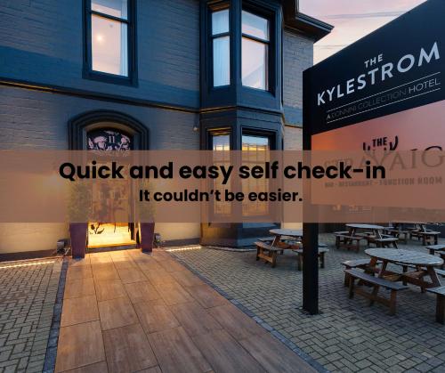 a building with a sign that says quick and easy self check in at The Kylestrome in Ayr