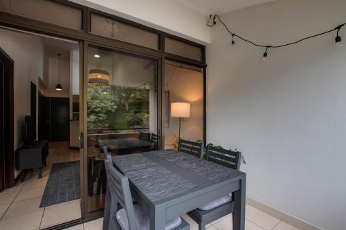 a dining room with a table and a glass door at CR MARIPOSA RENTALS Mountain view near pool in Santa Ana