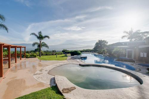 a swimming pool in the middle of a resort at CR MARIPOSA RENTALS Mountain view near pool in Santa Ana
