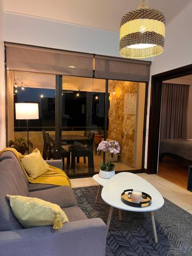 a living room with a couch and a table at CR MARIPOSA RENTALS Mountain view near pool in Santa Ana