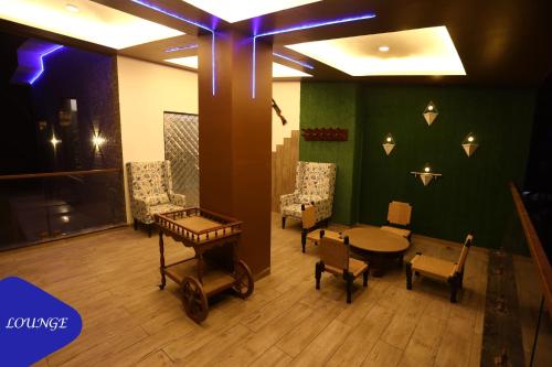 a room with a table and chairs and a table at Royal Retreat Lonavla - 7BHK Luxury Villa with Turf in Lonavala