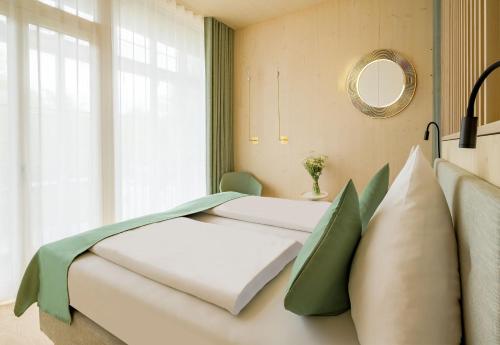 two beds in a room with a window at Hotel Krone Oettingen in Oettingen in Bayern