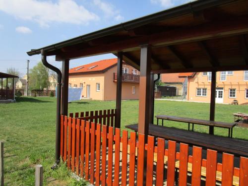 a wooden fence with a gazebo in a park at Penzion Semerád v Hevlíně in Hevlín