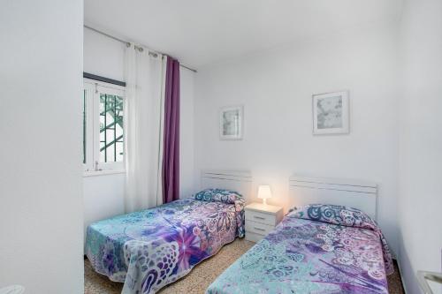 a bedroom with two beds and a window at Apartamento Los Angeles 2 in Puerto de Mogán