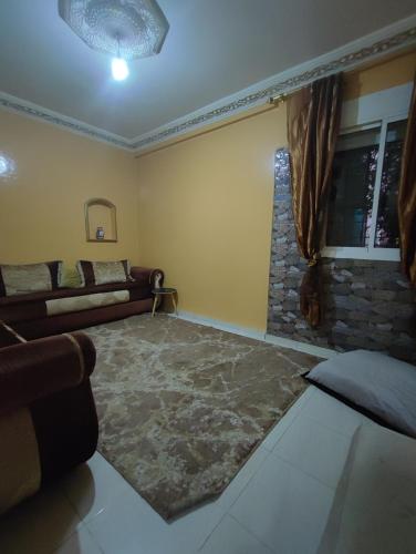 a living room with a couch and a window at zone 44 Massira 3 in Marrakech