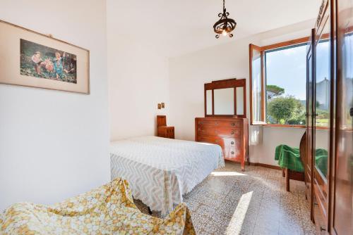 a bedroom with a bed and a window at La Terrazza sul Forno - Goelba in Portoferraio