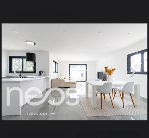 a kitchen and a living room with a table and chairs at Maison in Belleneuve