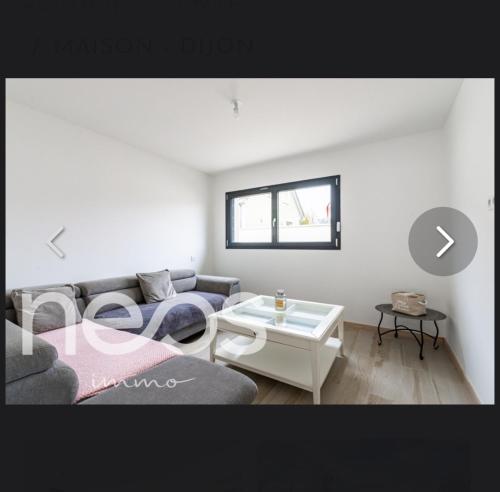 a living room with a couch and a table at Maison in Belleneuve