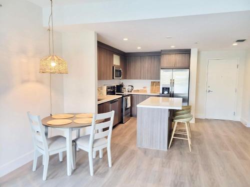 a kitchen and dining room with a table and chairs at NEW Modern Condo FREE Parking & High Speed Wifi in Hollywood