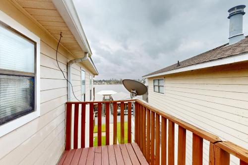 a balcony of a house with a wooden deck at River on the Pointe in Ventress