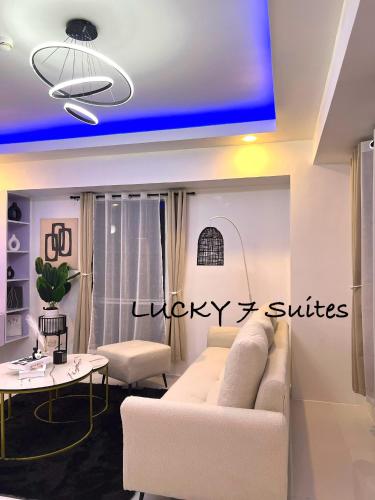 a living room with a couch and a table at Lucky 7 Suites in Manila