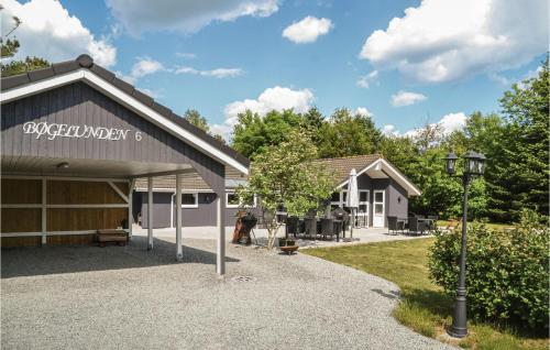 a building with a sign for a garage at Holiday Home Bøgelunden Oksbøl Ii in Oksbøl