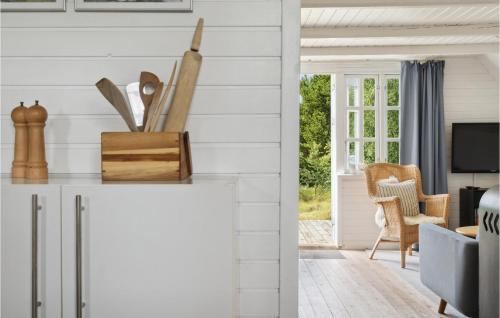 a kitchen with white walls and a living room at 3 Bedroom Amazing Home In Fanø in Fanø