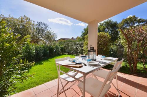 a white table and chairs on a patio at Residence in Costa Rei just 450 meters from the beach, apartments with air conditioning and outdoor private area in Costa Rei