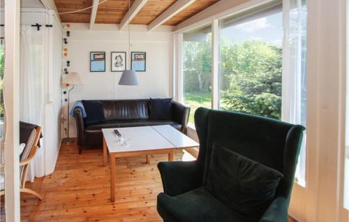 a living room with a couch and a table and chairs at Beautiful Home In Samsø With Kitchen in Onsbjerg