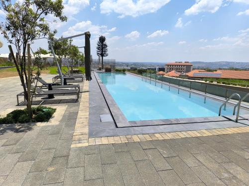a swimming pool on the roof of a building at Waterfall Luxury Apartment in Midrand