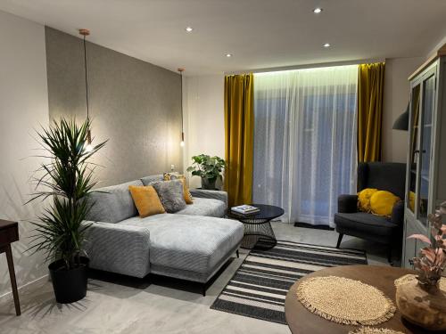 a living room with a couch and a table at Kal's Studio Apartment Salzburg in Salzburg