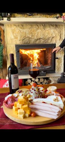 a plate of meats and cheese and a bottle of wine at Rokwood faraya in Ash Sha‘rah