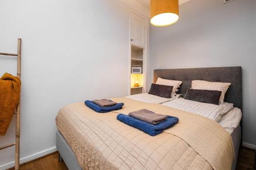 a bedroom with a bed with two pillows on it at Prime City Escape 45 Square Meters in Helsinki